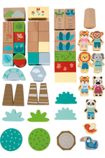 Collection of wooden toys including blocks, animal figures, and nature-themed pieces on a white background.