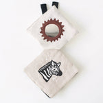 Baby teething ring and soft book with zebra design on a white background