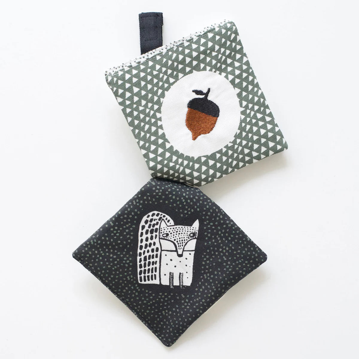 Two fabric toys with geometric patterns and animal designs on a white background