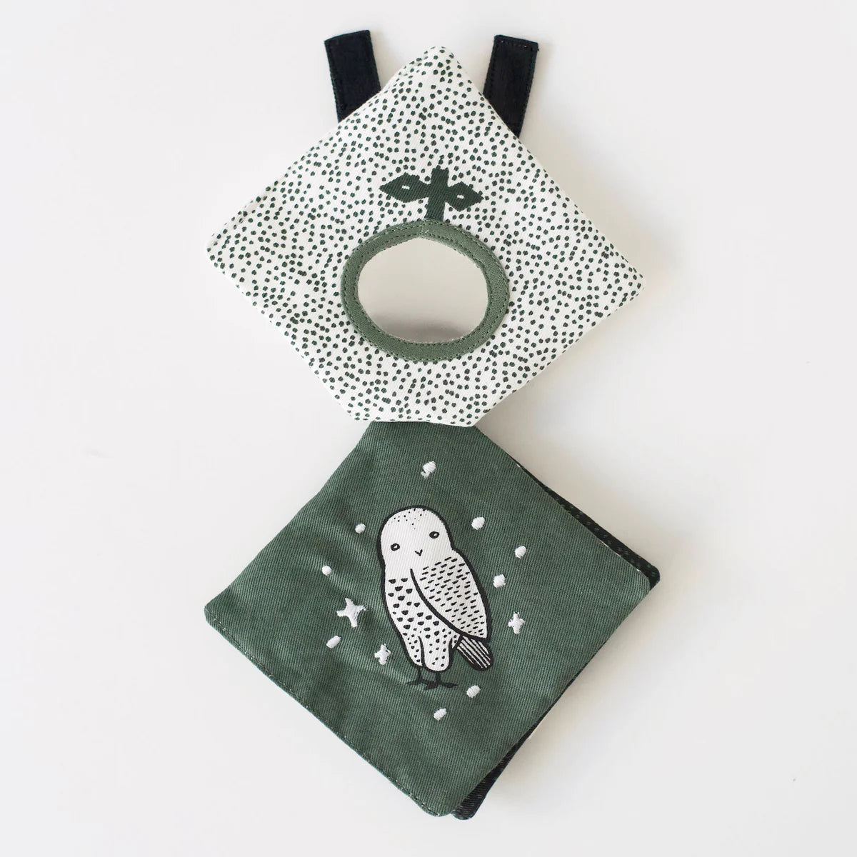 Two baby toys on a white background, one with a polka dot pattern and the other with an owl design.