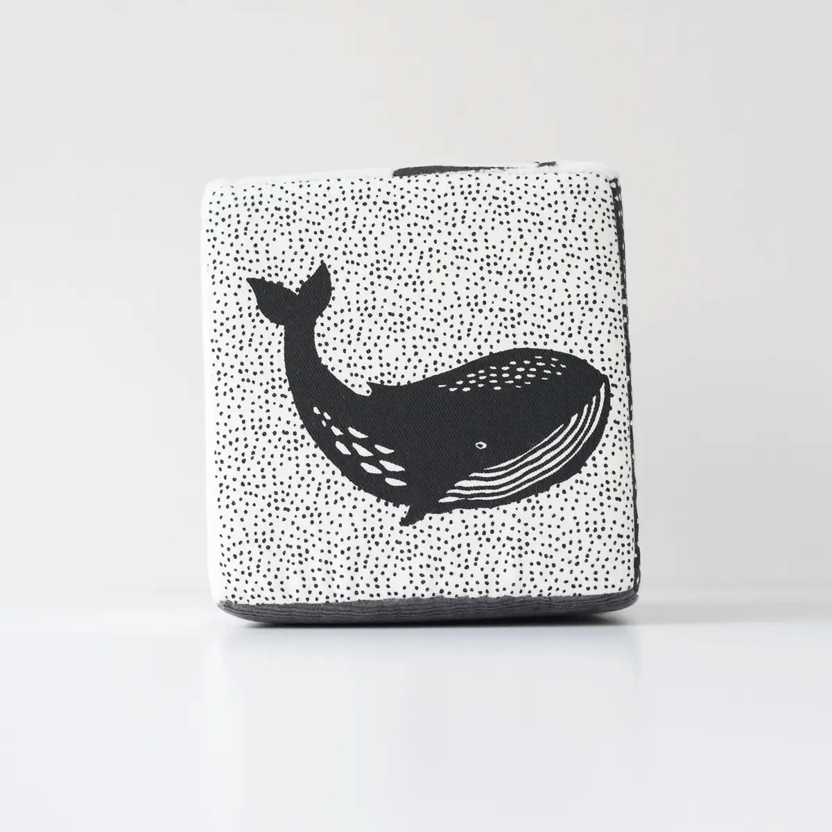 Rectangular pouch with black whale design on a white background