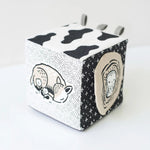 Black and white cube with animal illustrations on a light gray background
