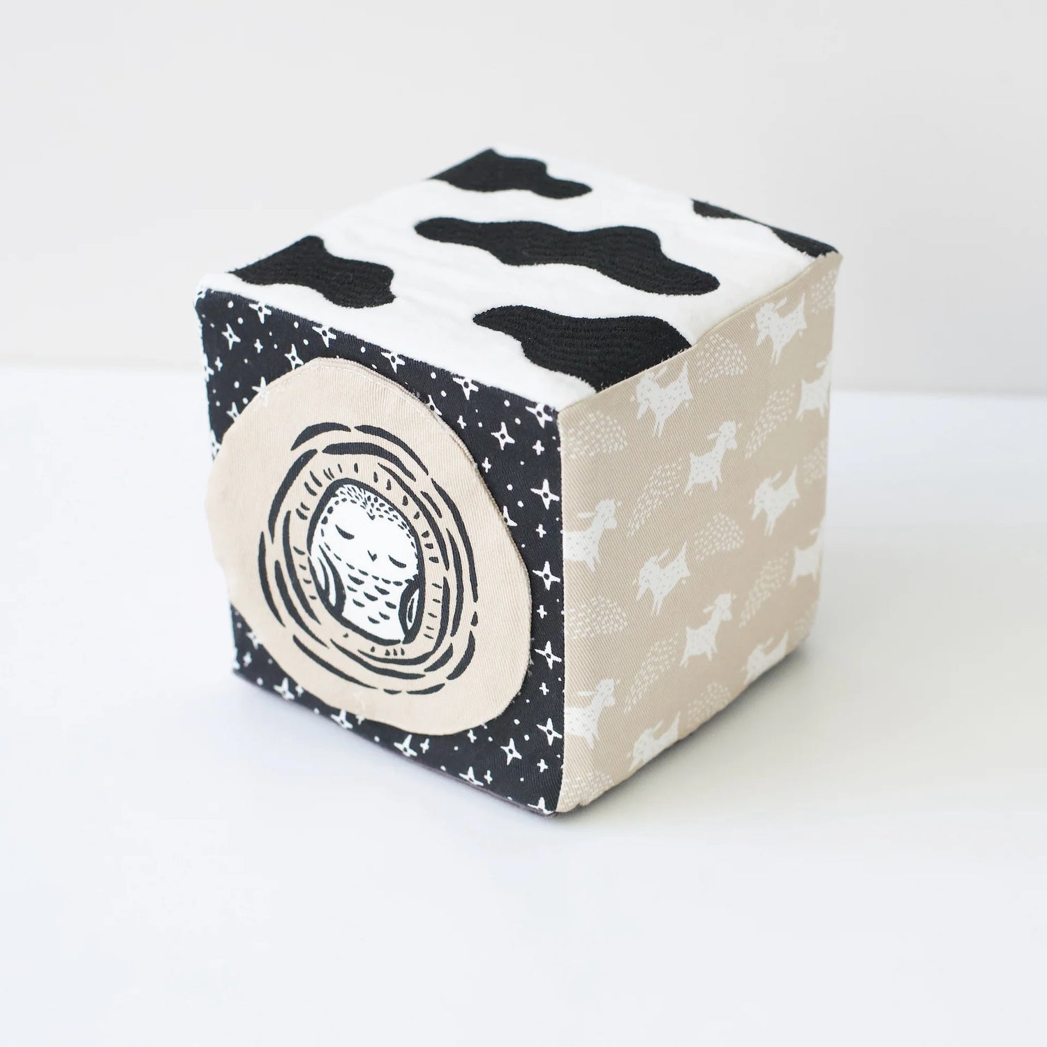 Cube-shaped block with black and white patterns on a white background