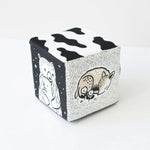 Cube-shaped container with black and white illustrations of animals on a white background