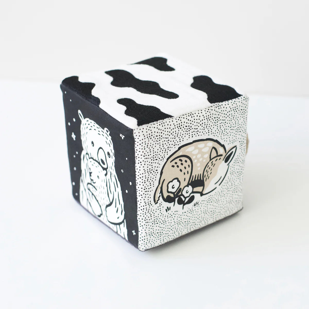 Cube-shaped container with black and white illustrations of animals on a white background